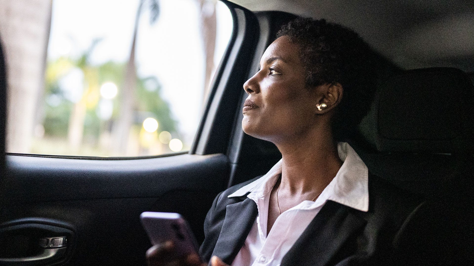 Woman looking out the window on a car