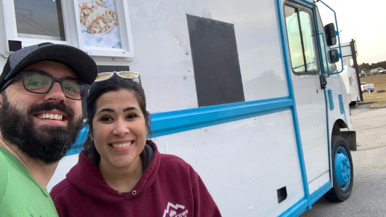 Chris Mullen and his wife Sara take a selfie in front of their waffle truck. 