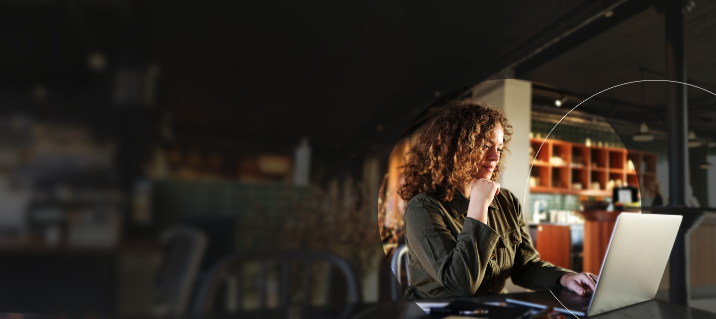 Woman on laptop working in coffee shop