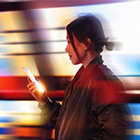 abstract image of woman holding phone depicting movement