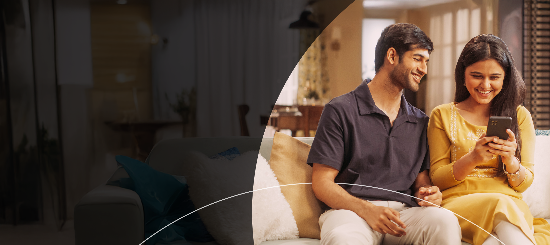 Man and woman looking at phone on the couch