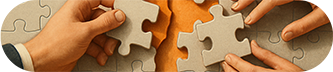 Les mains assemblent des pièces de puzzle, symbolisant le travail d'équipe et la résolution de problèmes.