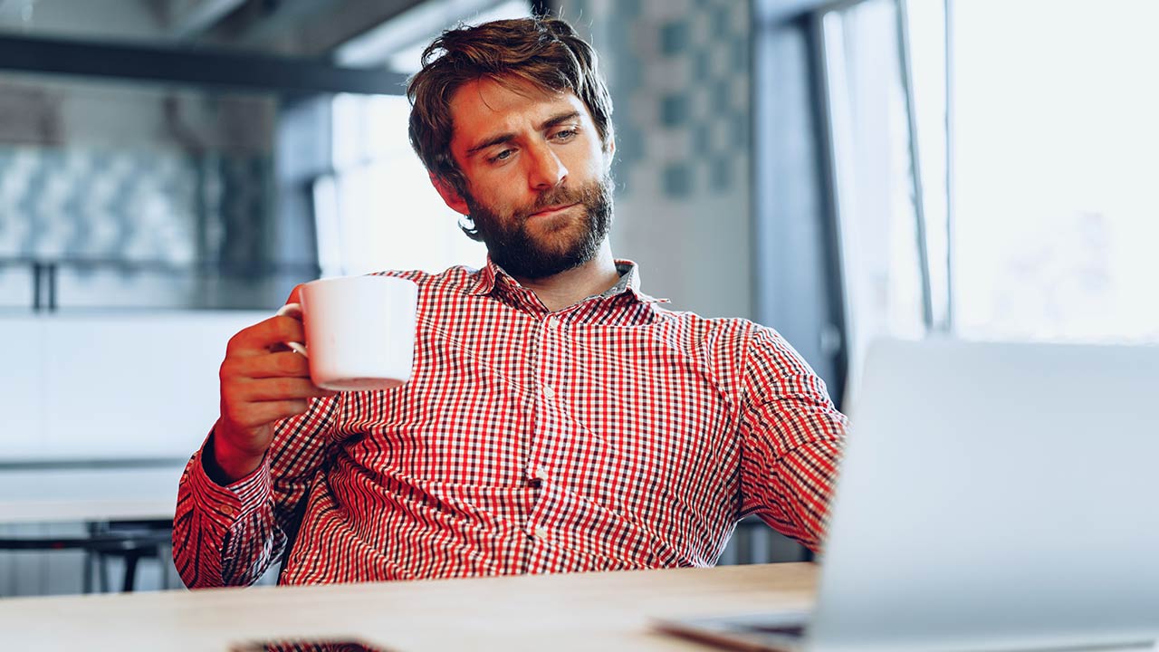 Hombre observando la pantalla de la computadora en la oficina.
