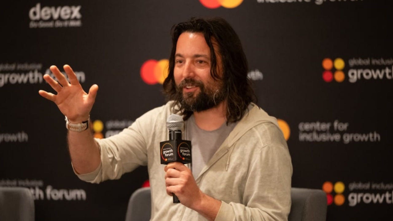 Tom Szaky at GIGF on stage holding a microphone and gesturing with his right hand. 