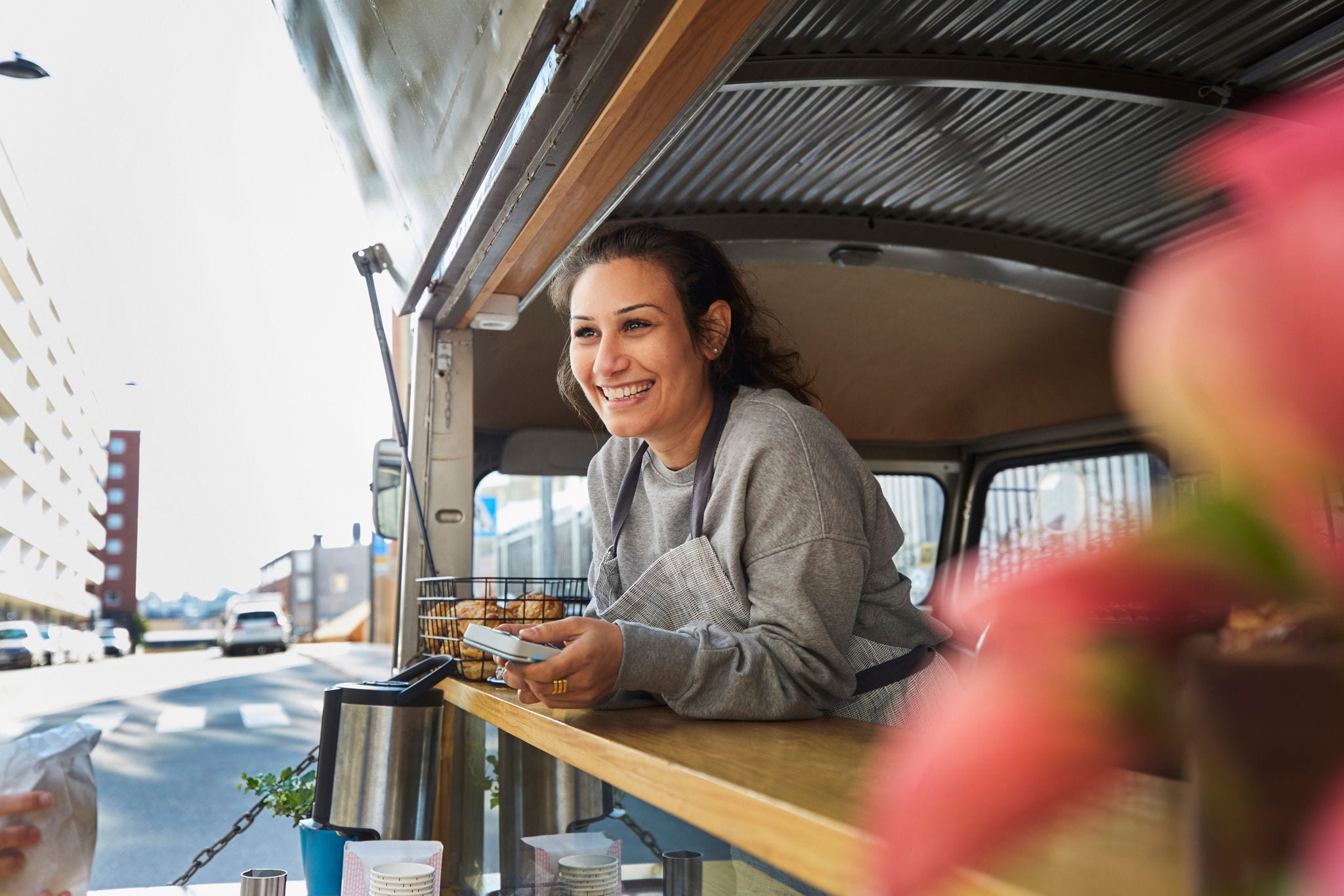 Woman smilling while managing her food truck