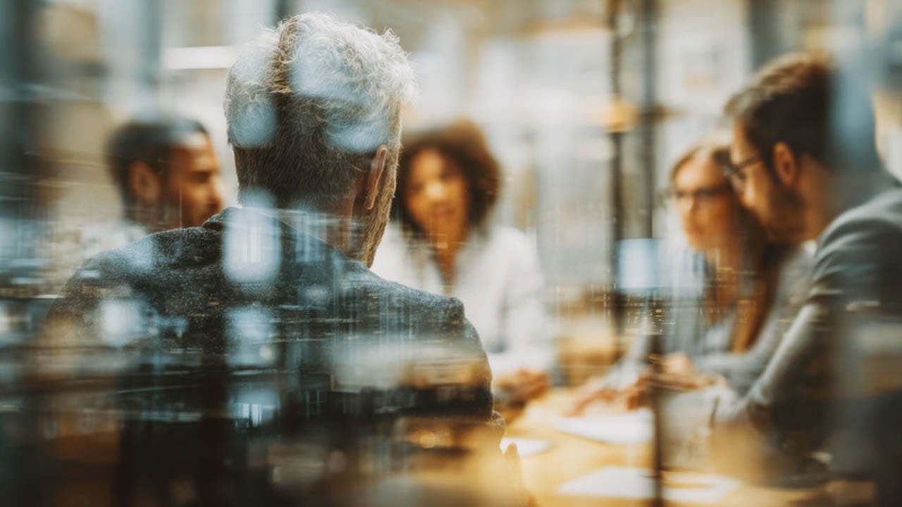 Diverse team collaborating in a modern office setting fostering innovation and strategic planning for future success with a focus on leadership.