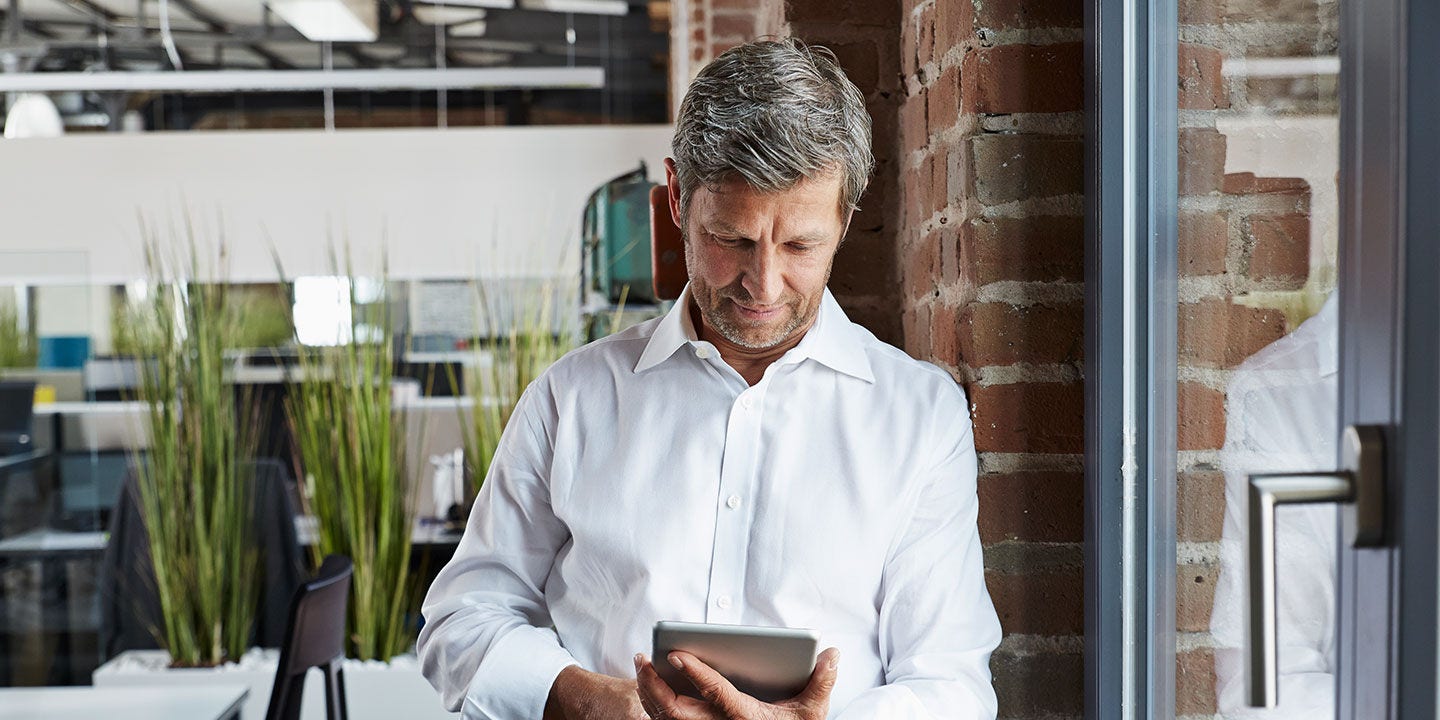 Businessman in office looking at digital tablet