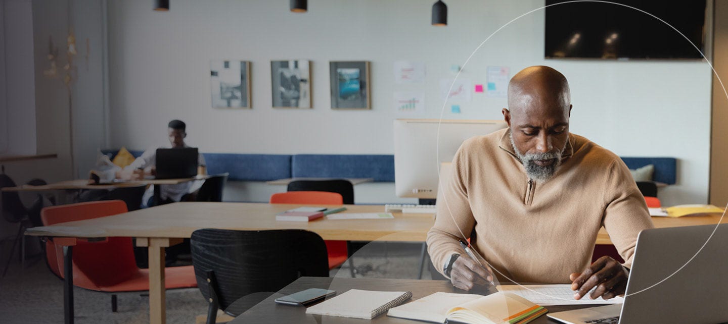 focused man writing at office desk