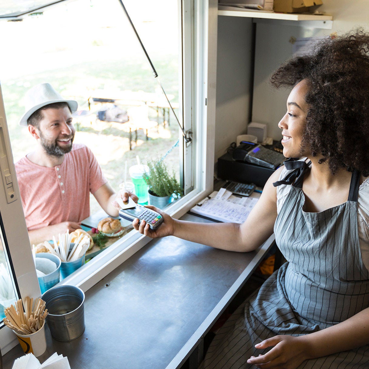 Female food truck owner taking payment