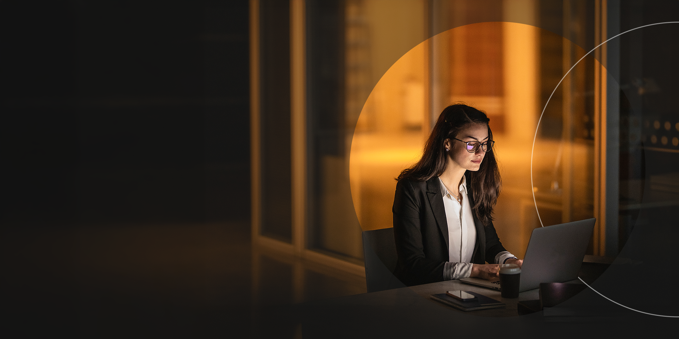 Mujer trabajando en su escritorio a altas horas de la noche en una oficina.
