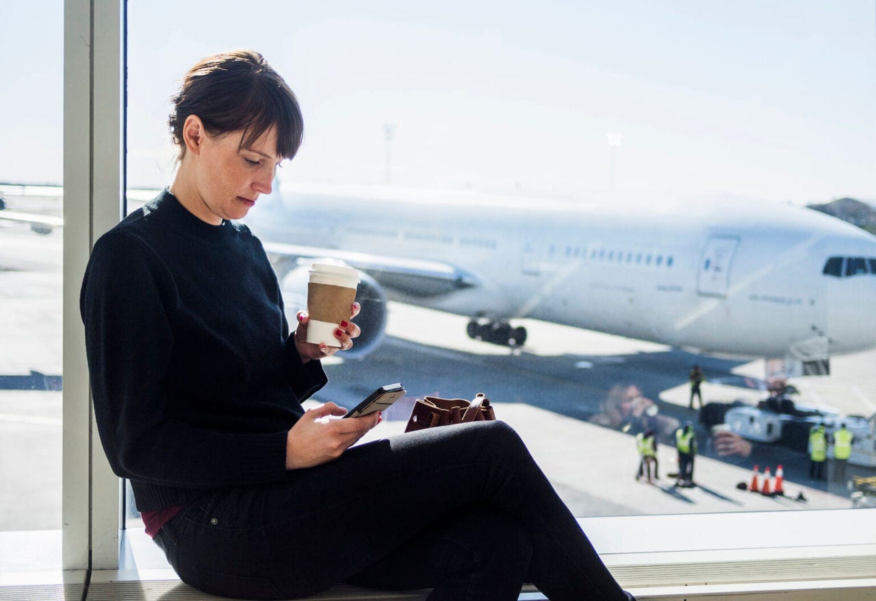 Woman on phone at the airport