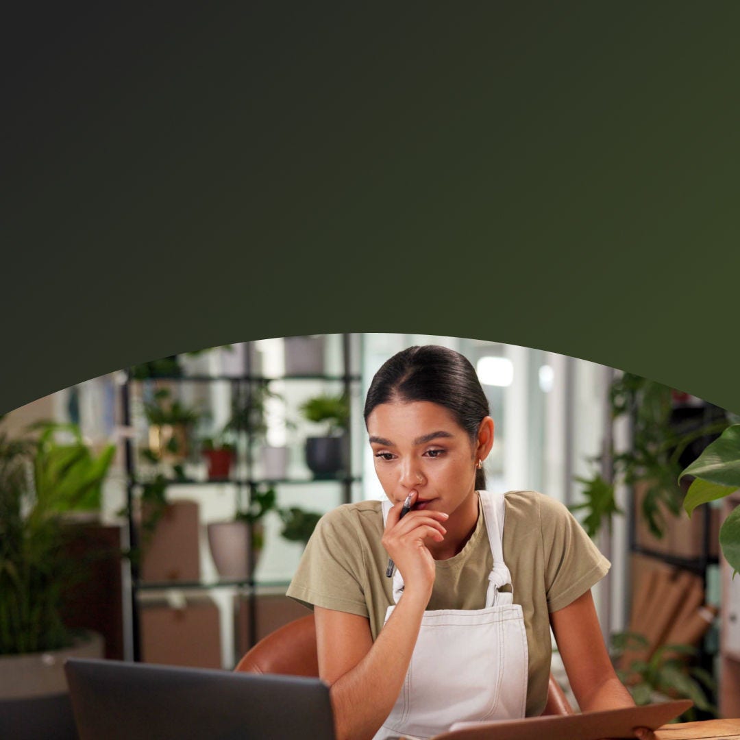 Female owner of a plant shop doing paperwork on her laptop