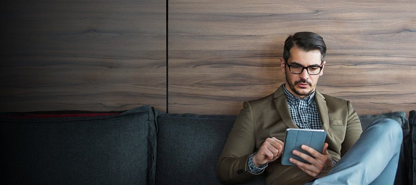 man using tablet on the couch