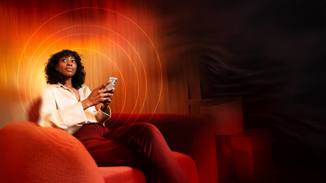 Woman looking into distance in front of laptop