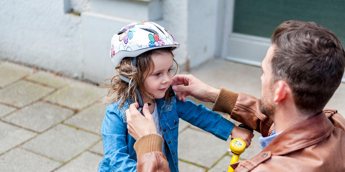 Father and daughter playing with bicycle