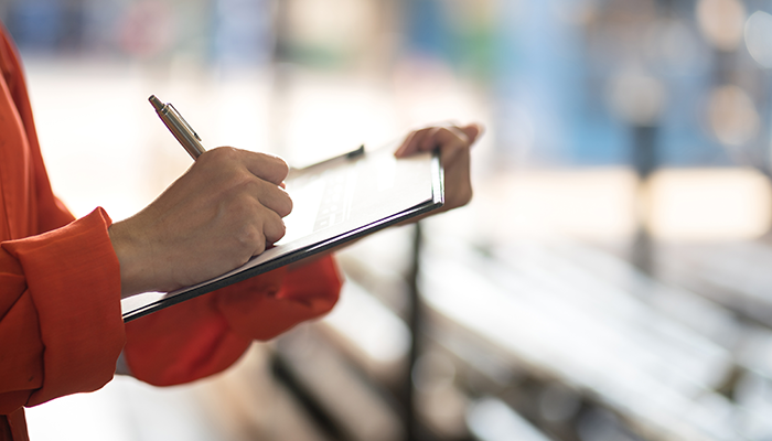 Man using his phone wearing a red bag