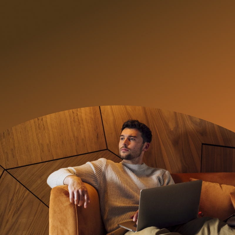 man with laptop on a couch