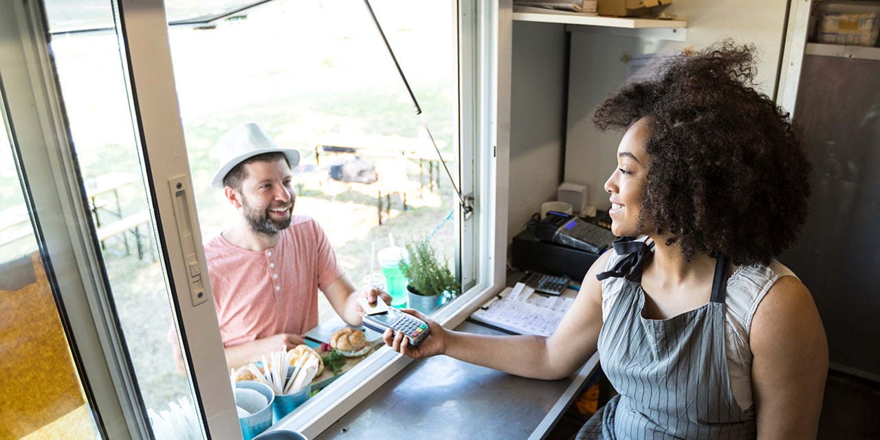 Man paying at a food truck