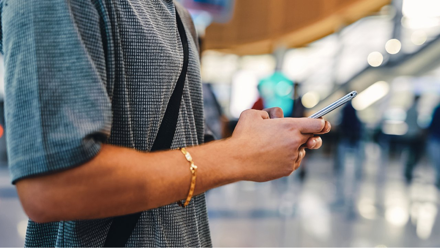 Close up of man typing on mobile phone