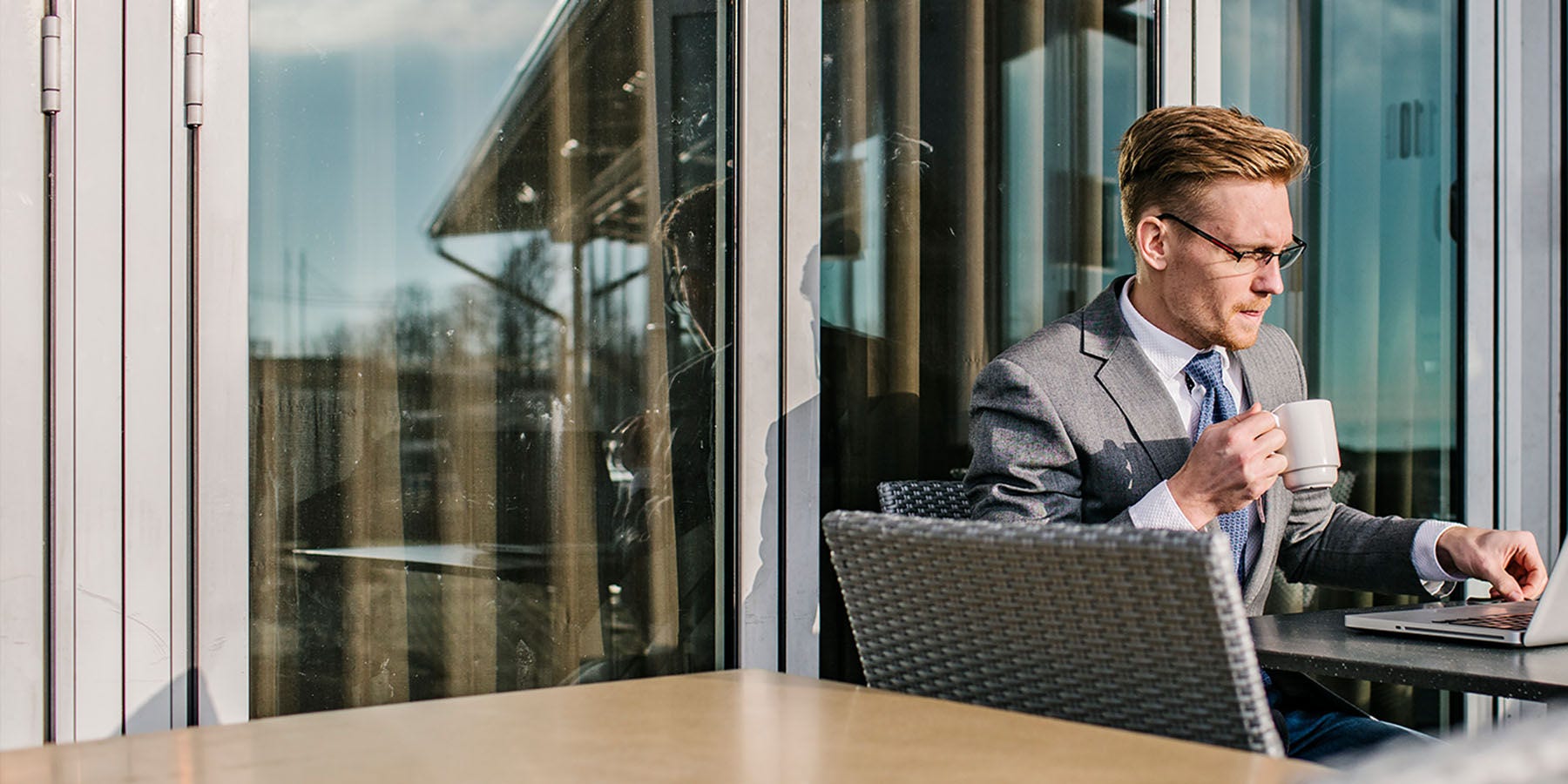 Bank employee drinking coffee