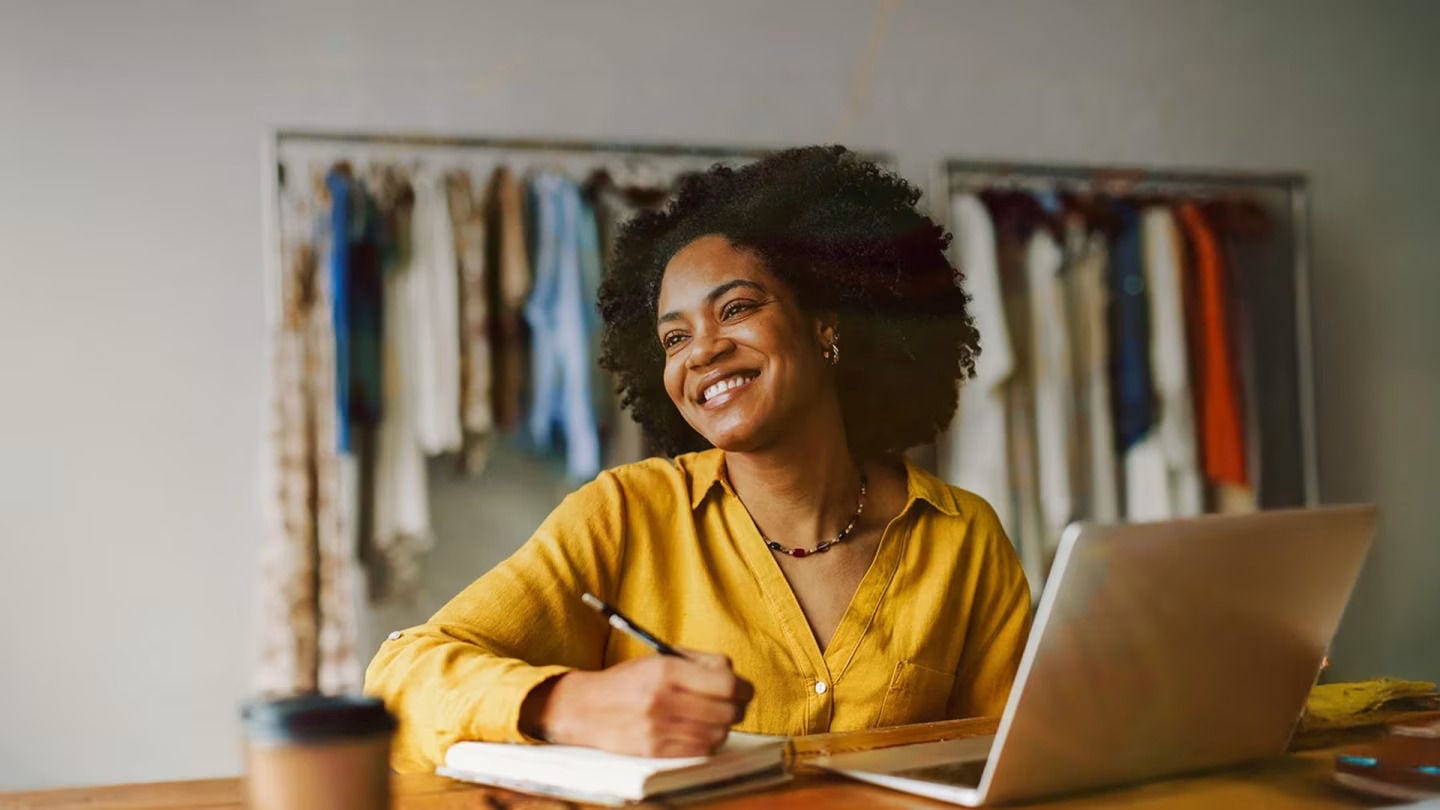 Smiling woman working on laptop