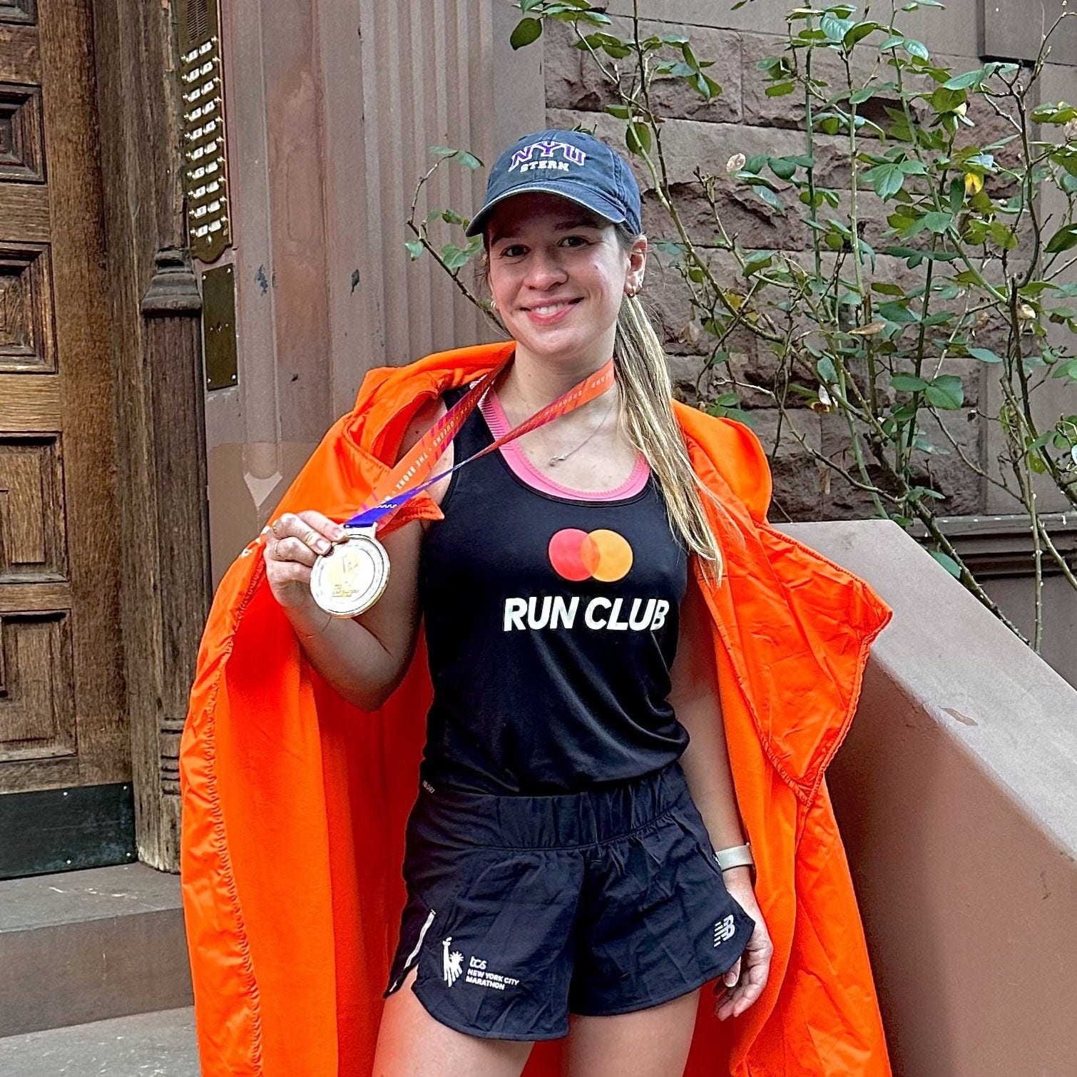 Anyel Arslanian wearing a Marathon run club tank after running the NYC Marathon. 