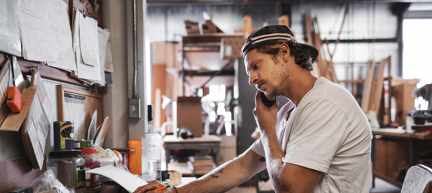 Man on the phone in a workshop