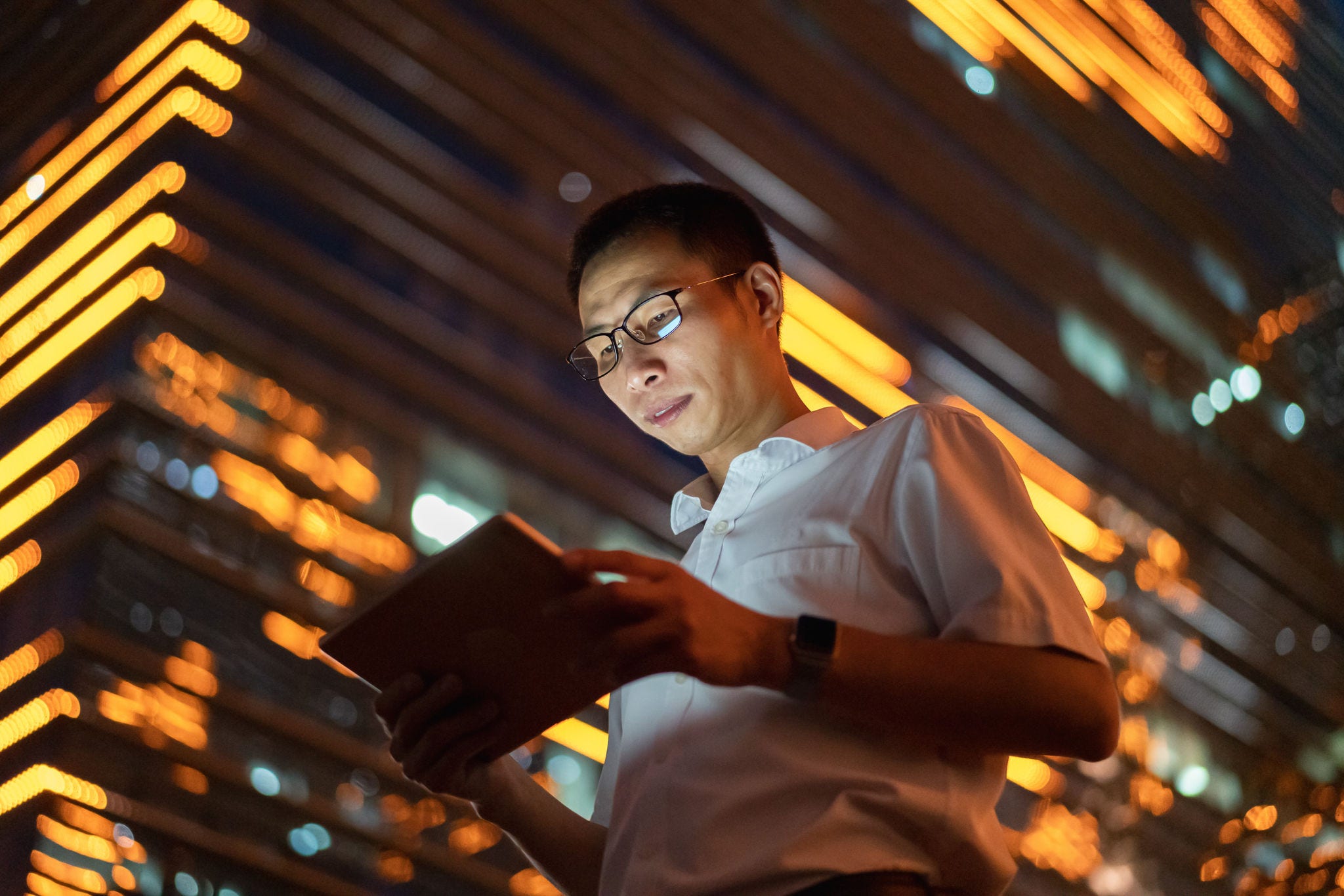 Man on tablet at night