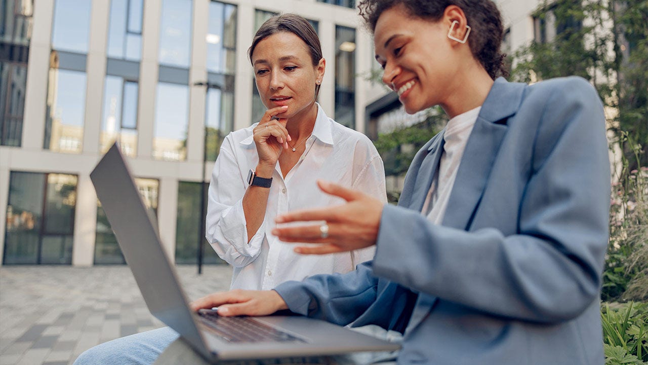 Two business coworkers working outside of an office.