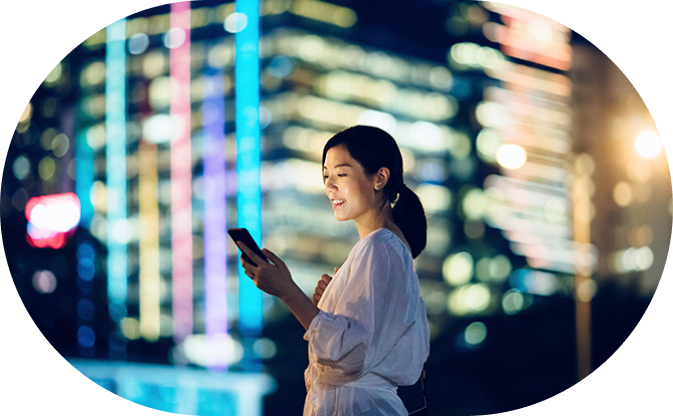 Woman looking at phone and smiling.
