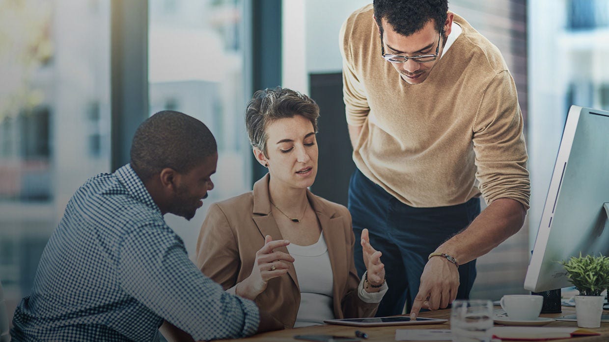 Three people in a conference room discussing Money Movement