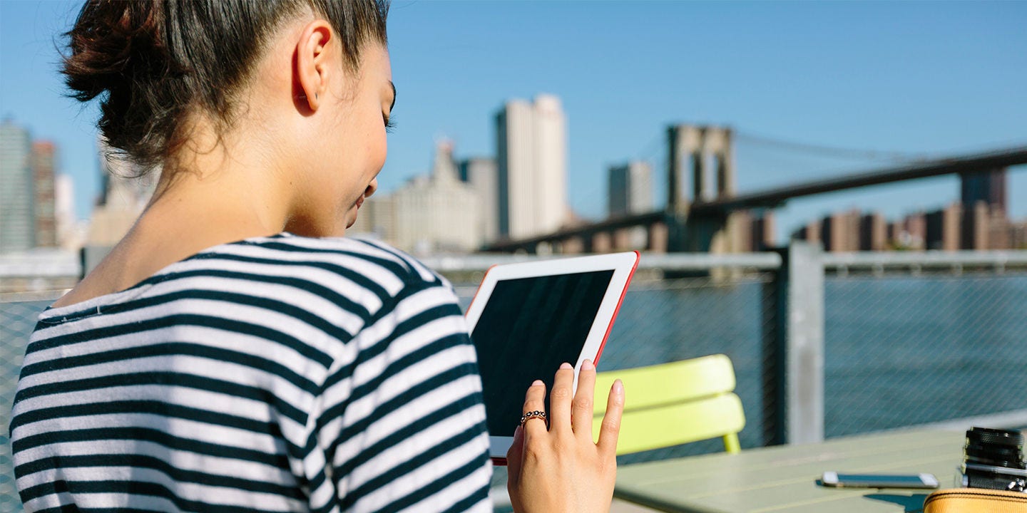 USA, New York City, smiling young woman with digital tablet