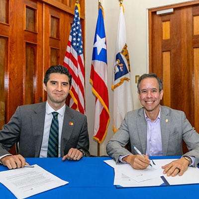 Two men signing an agreement at office.