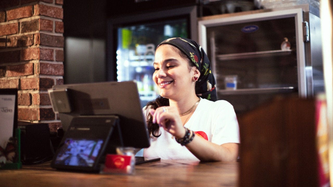 Lorena Jorge behind the register at Morena's Kitchen & Bar