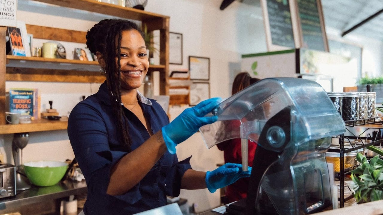Kenesha Lewis prepares a smoothie in her business. 