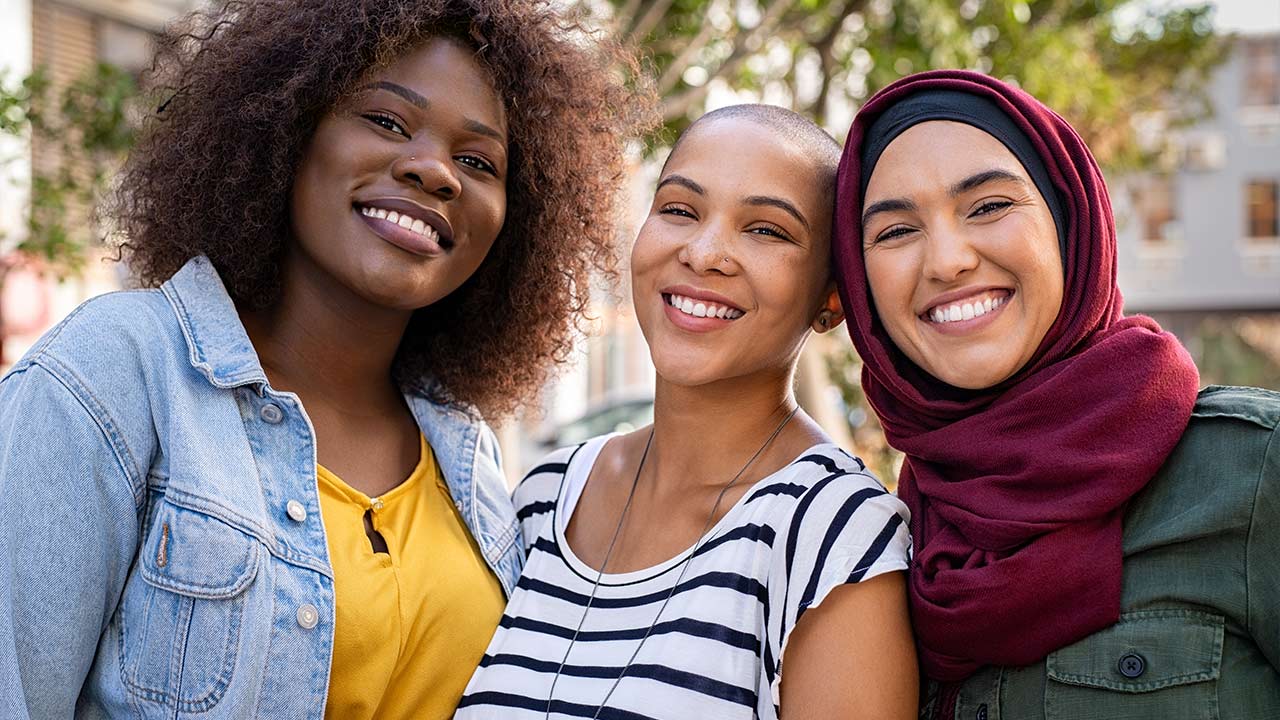 Multiethnic young friends smiling together.