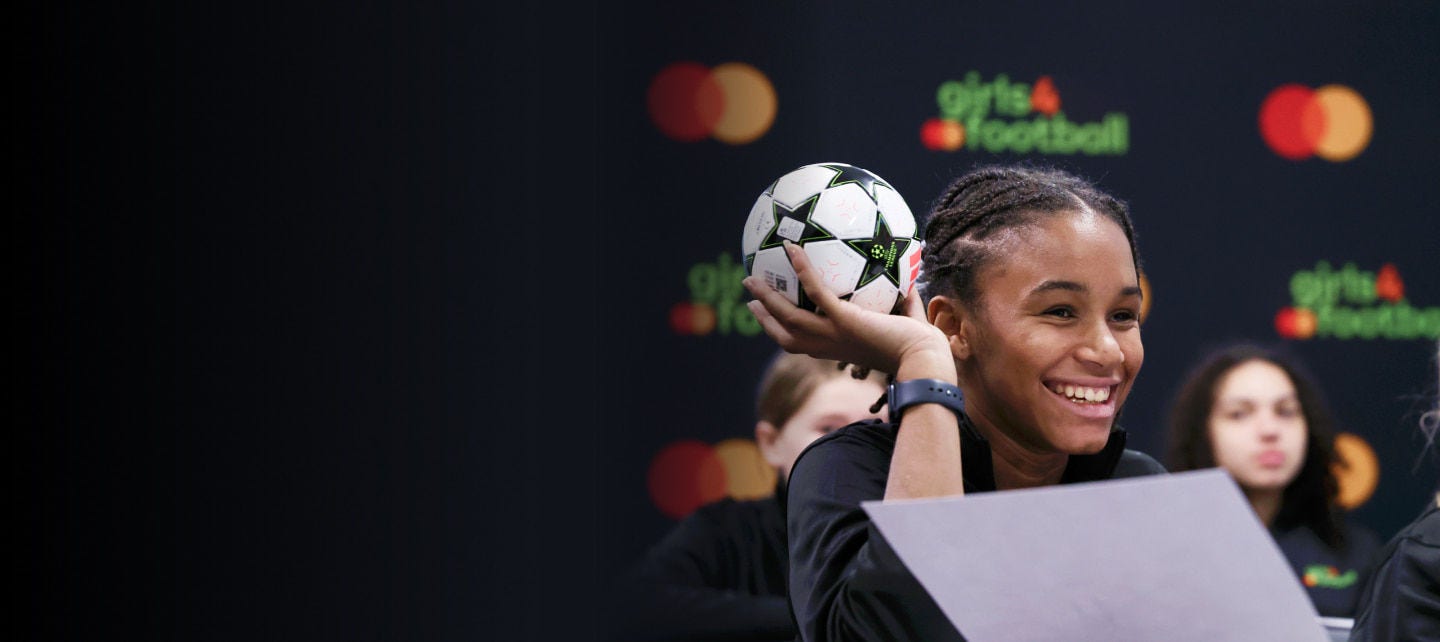 smiling girl holding football in class