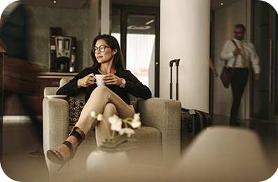 Business woman having coffee at airport lounge.