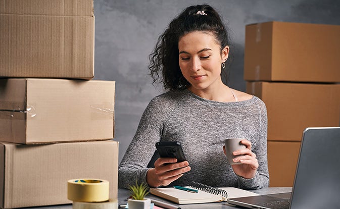 Woman using phone in office purchase department.