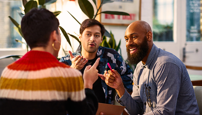 Trio of people talking in the office