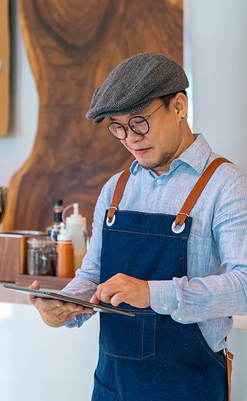 Male store owner checking his website.