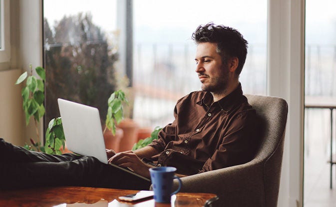 Man reading on his laptop