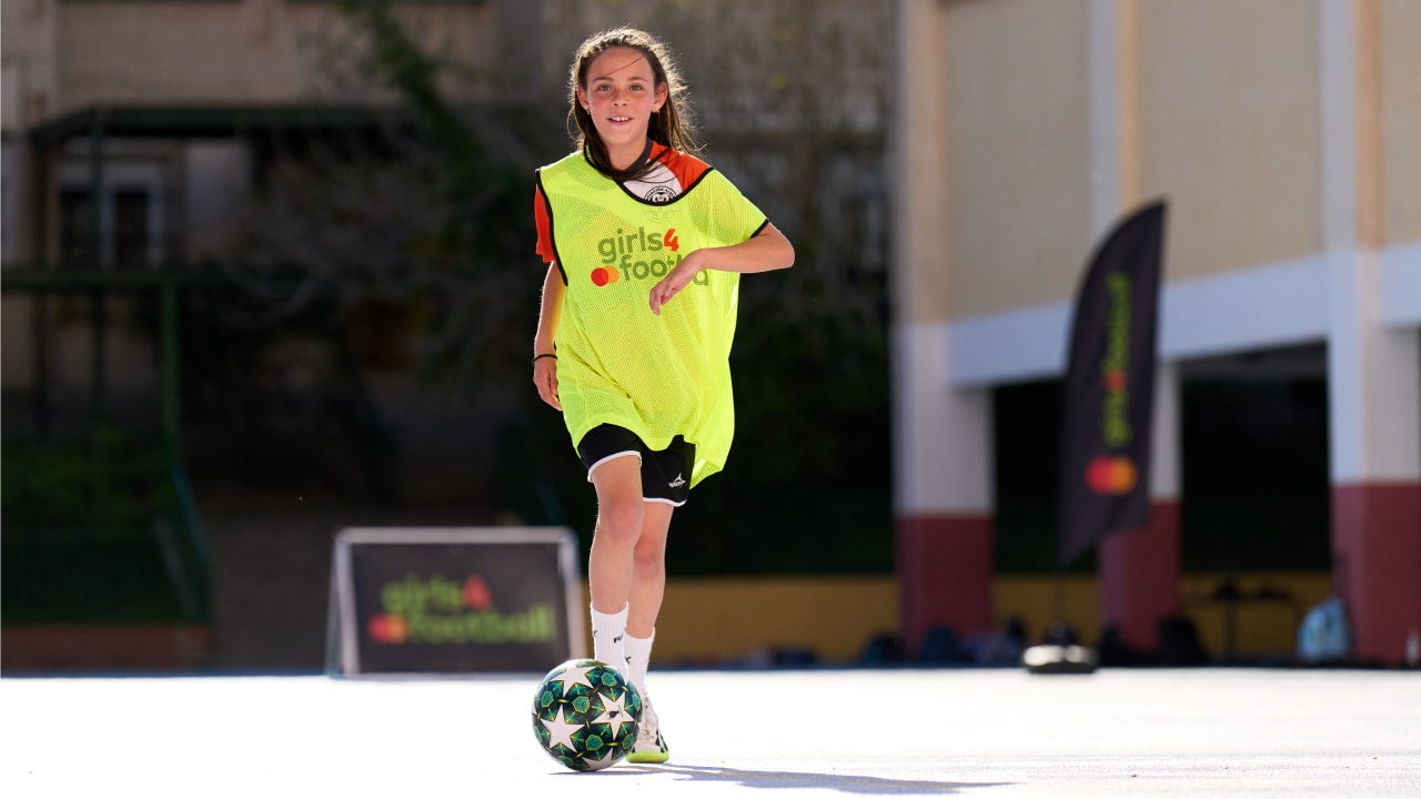 girl dribbles with a ball