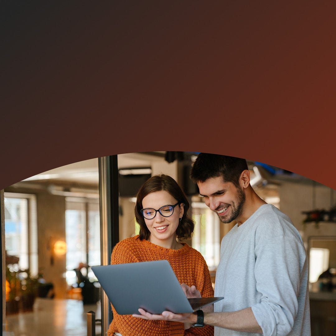 Man and a woman standing with a laptop