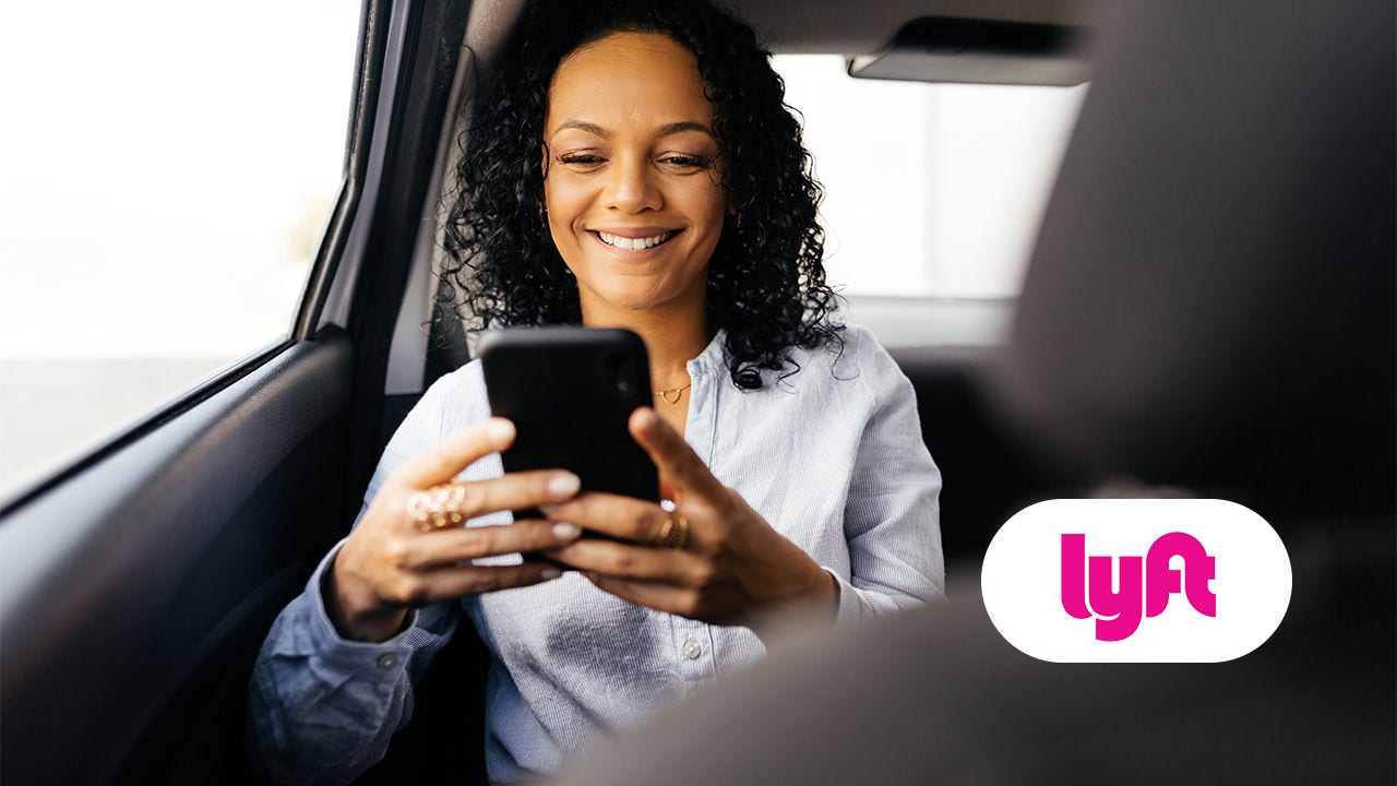 Woman in a car. Lyft logo.
