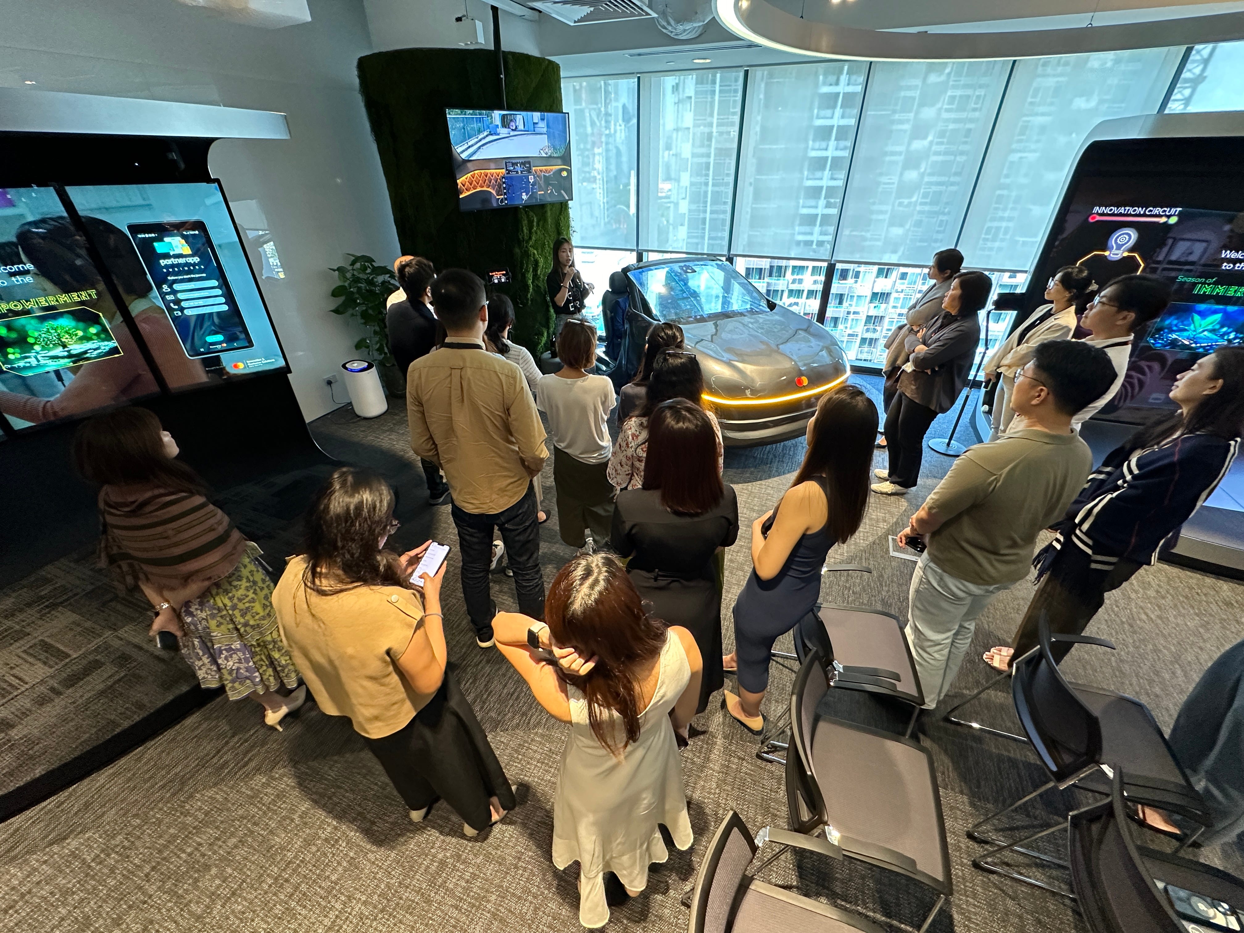 People gathered around concept car at Mastercard Experience Centre.