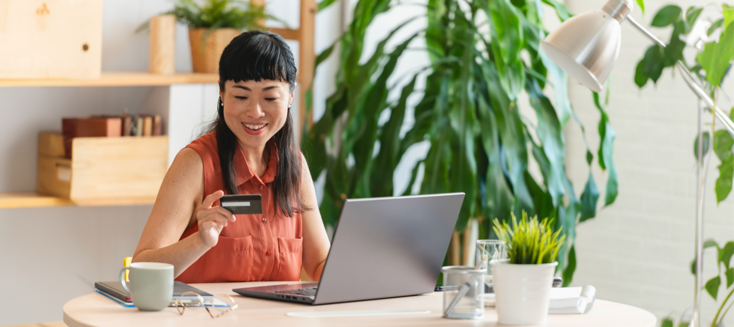 Woman making a purchase using her card on her laptop
