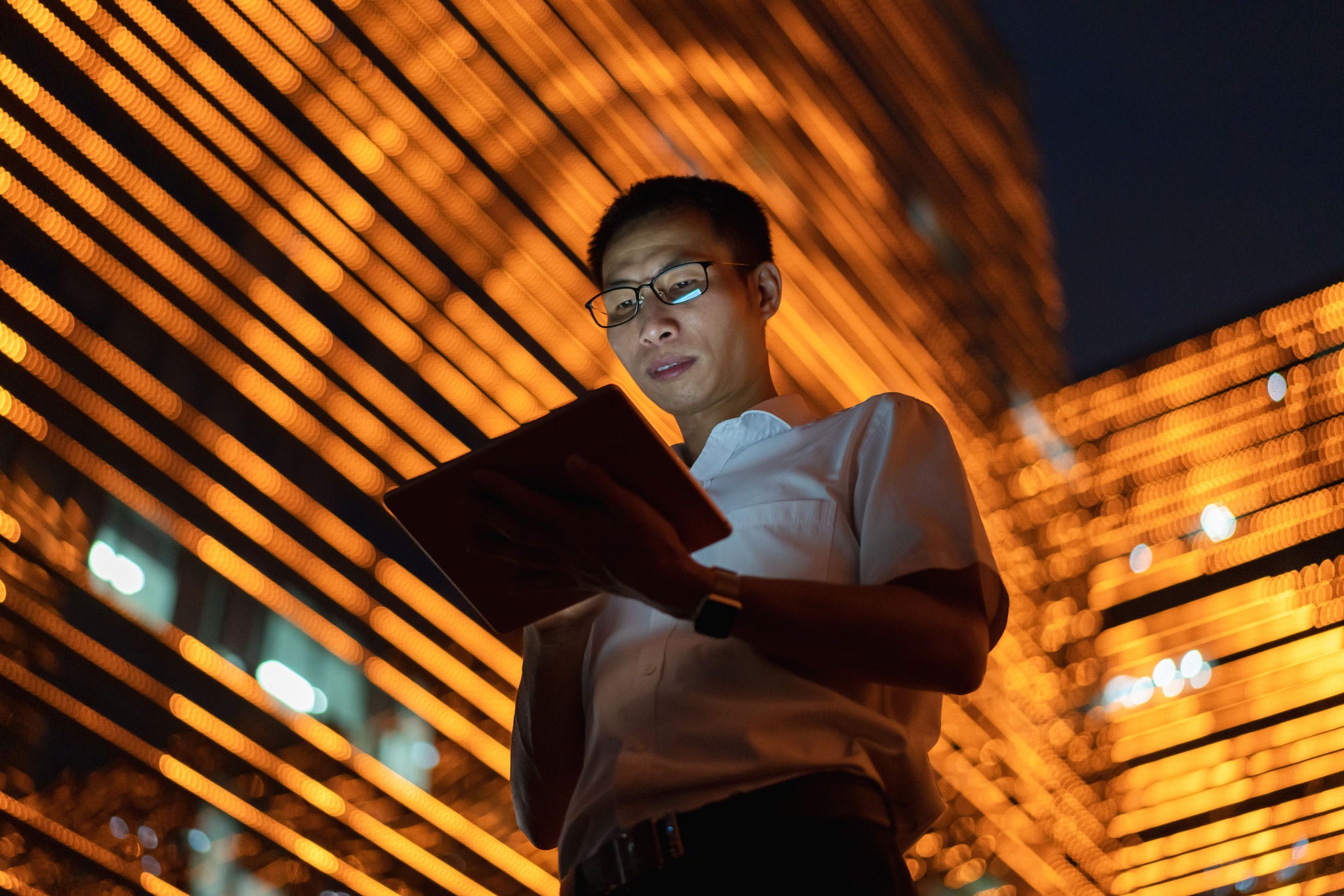 A man is doing something on tablet screen.