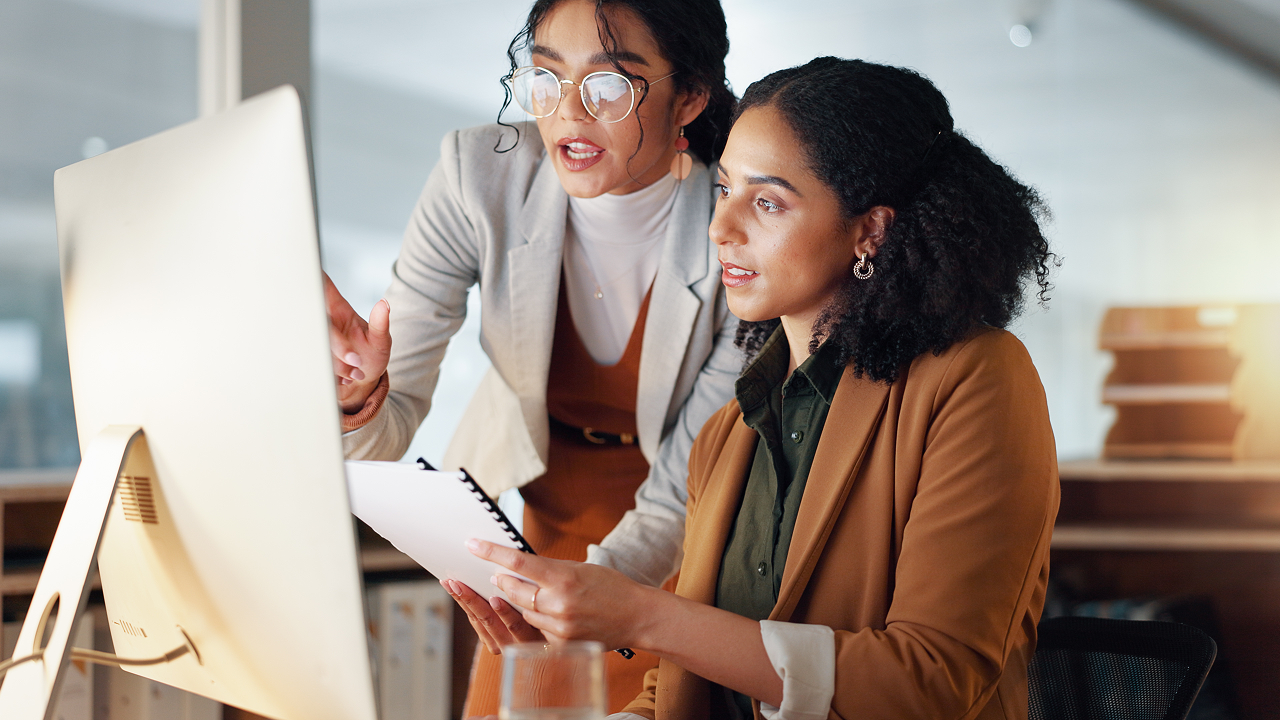 Two women looking at a computer