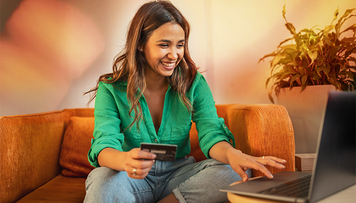 Woman on computer putting her card number in